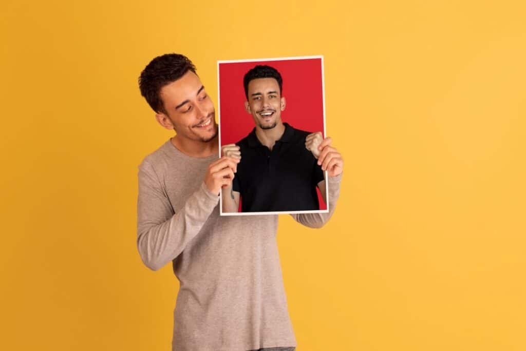 Man holding a photo up to the camera