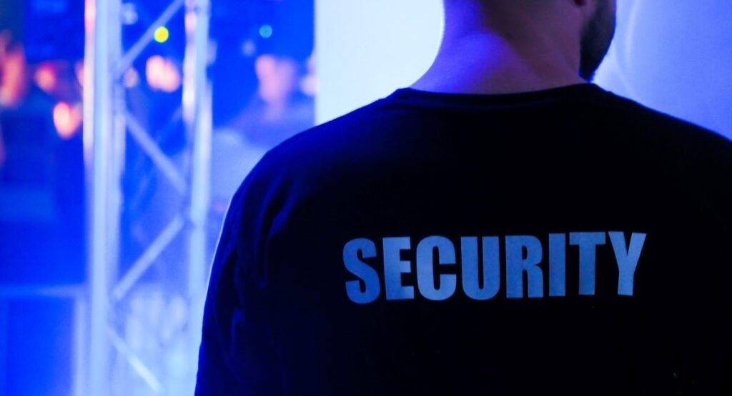 Back of a bouncer's shirt that says "Security"