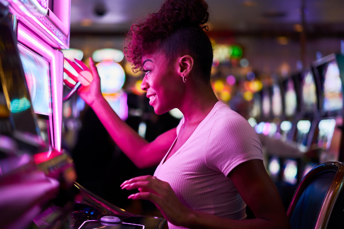 Woman playing a slot machine in a casino