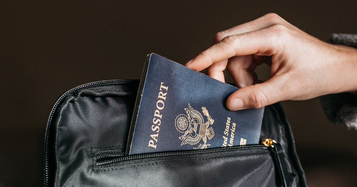 Person placing passport into black bag
