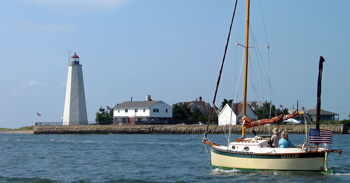 Lighthouse and sail boat in Connecticut