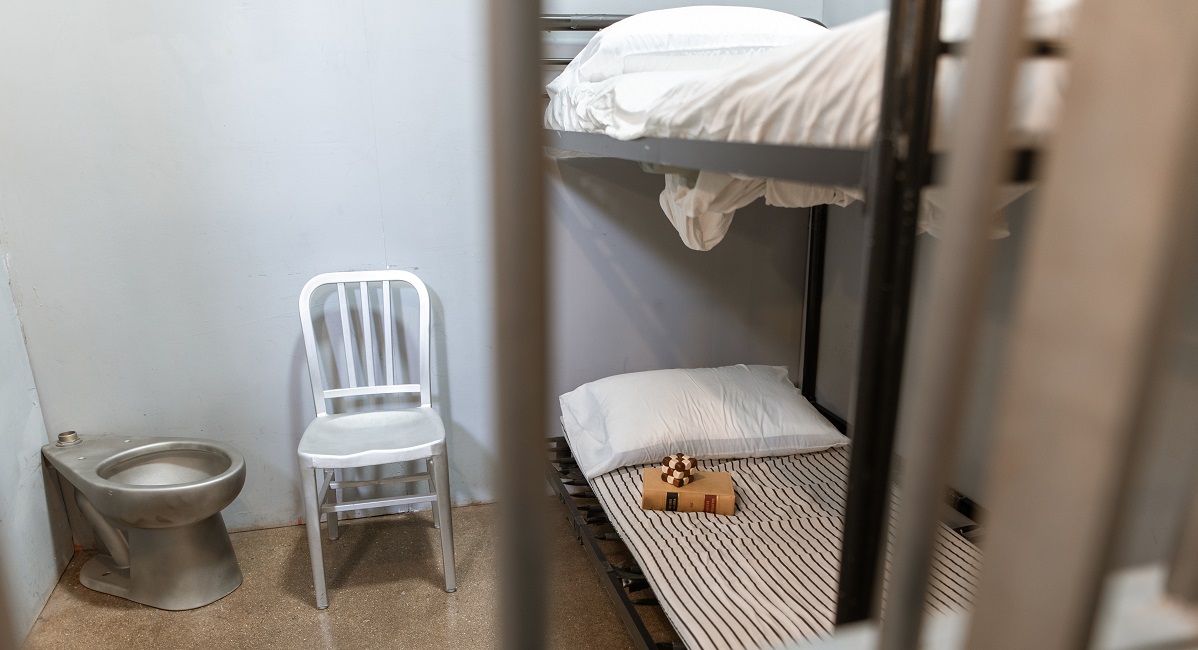 bunk beds behind prison bars