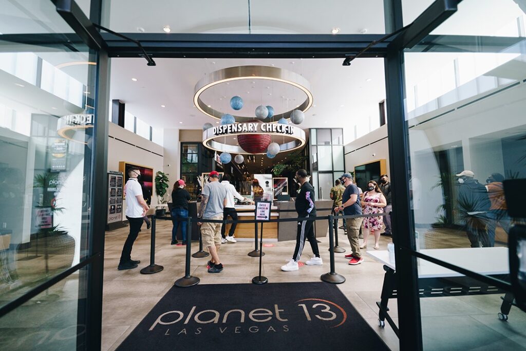 Entrance and ID scanning queue at Planet 13 cannabis dispensary