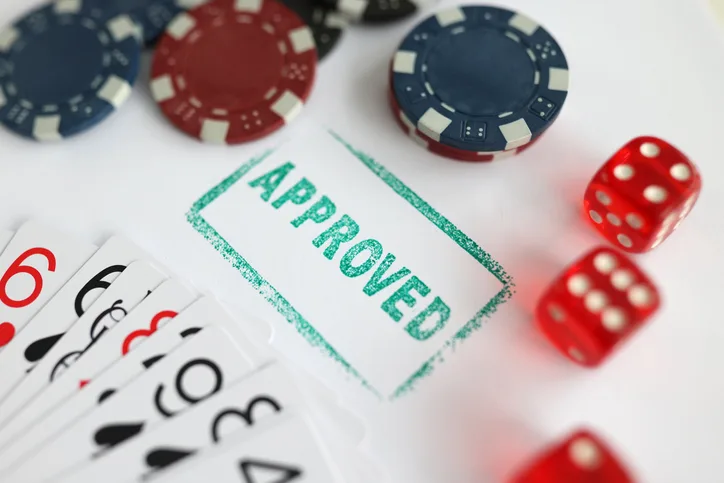 Casino chips, dice, and cards with "approved" stamp to show casino ID verification
