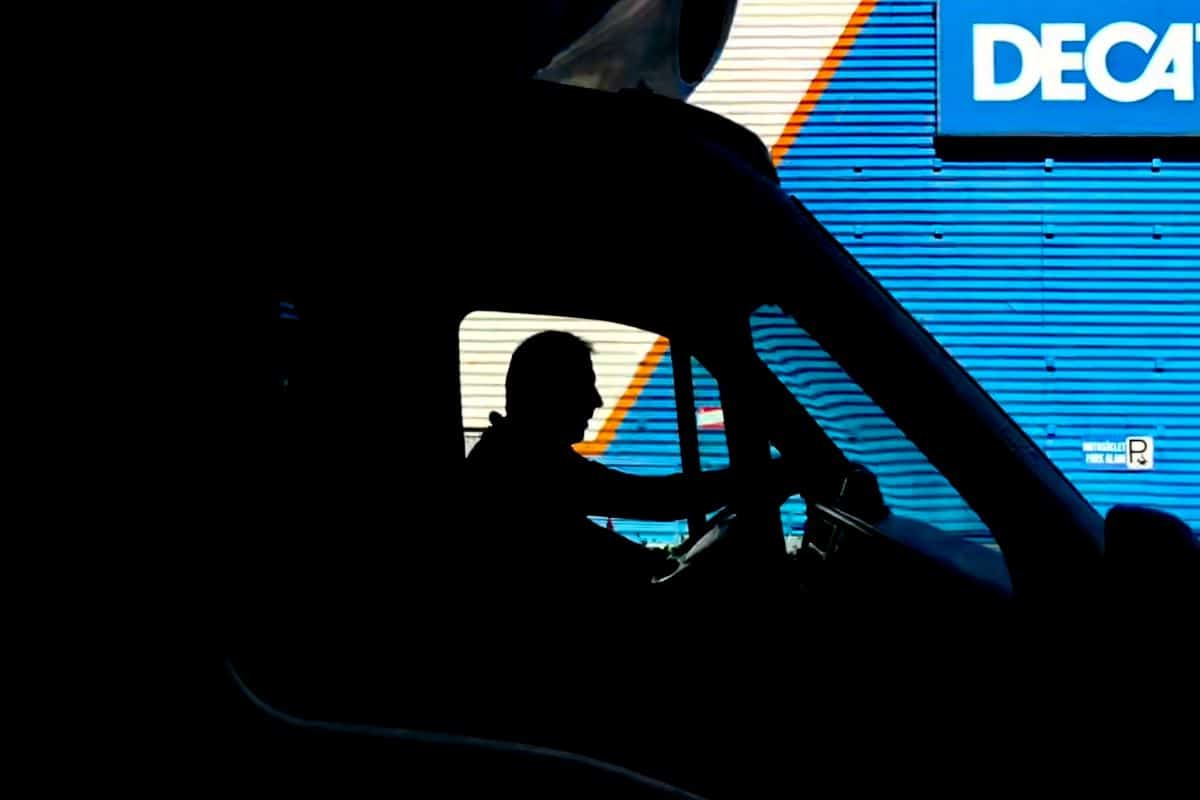 Man in a truck waiting to get his ID scanned