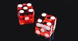 pair of red gambling dice on a black background