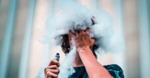 Person blowing smoke after using vape